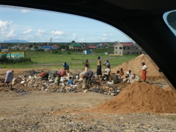 A group of folks looking through a rubble pile for I'm not sure what.