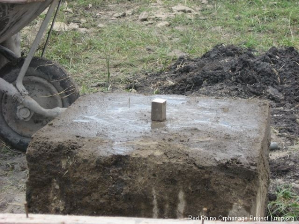 The other three were within a quarter inch of each other. This one for some reason was an inch and a half low. So we cut this piece of wood to that exact height and raised the level with concrete.