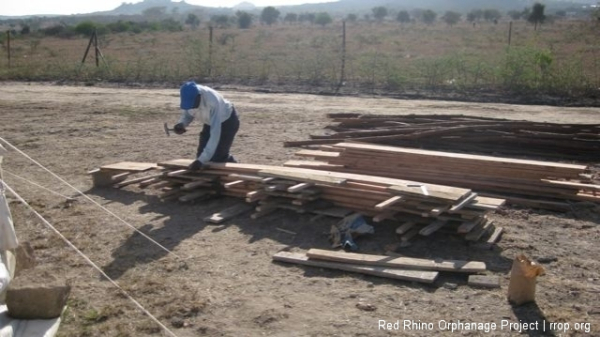 Opyo, the carpenter, was making the shuttering for the slab.