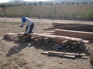 Opyo, the carpenter, was making the shuttering for the slab.