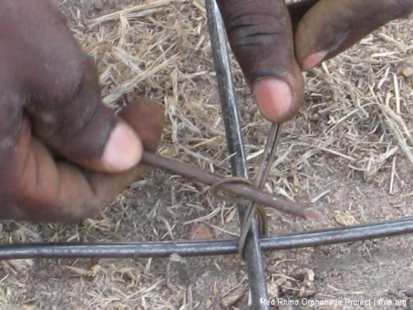 You take a length of binding wire, fold it in half, bend it in \"U\" shape, slide part of the \"U\" under the joint, slide a six inch nail into the loop, and then twist until it\'s tight.