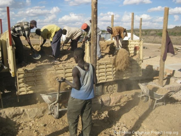 After the hard core was pounded, the guys added the murram on the layer and the compacting began again.