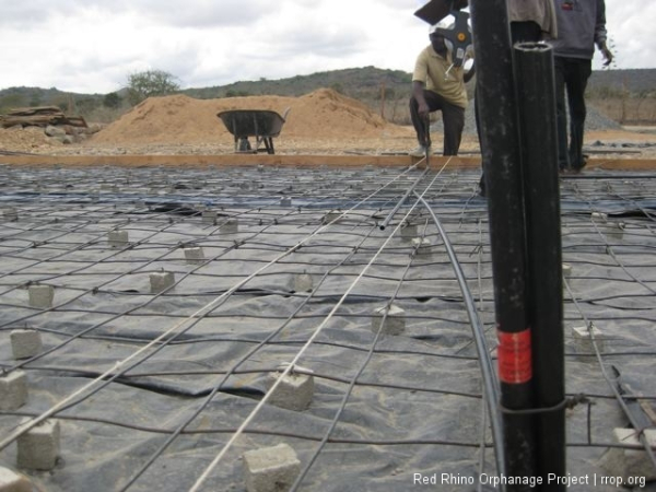 George, the electrician, came by to set in the conduit. It will be in the slab and so the electrical works will be ready to go when we build the walls. Sometime folks wait and then chip the concrete out to run the wiring. Didn\'t make must sense to me to do that. Those are our little cement spacing blocks with the wires in them that you saw in an earlier posting. They keep the BRC off the ground so it will be in the middle of the slab when it\'s poured.