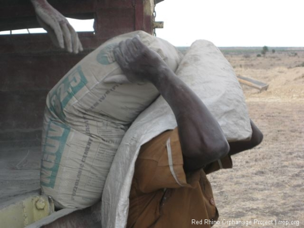 During the conduit fest, the hundred bags of cement that I ordered from Halleluliah Hardware showed up, and some of our guys started unloading. The bags are really dusty with fine concrete powder, so the guys opt for either the mysterious monk/Eyes Wide Shut look,