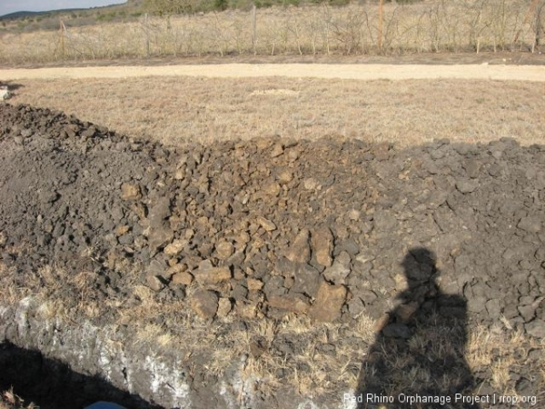 This brownish dirt in the middle of the pile is murram. This is the level we need to get to in all of the trenches before we can pour the foundation footings.