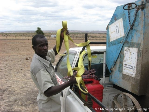 Gilbert unloading the cement mixer and holding one of my favorite things in the world. A woven, yellow, almost unbreakable tow strap.