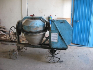 A friend of Christian\'s loaned us this cement mixer. It starts with a crank and its one cylinder diesel motor can chug along all day.