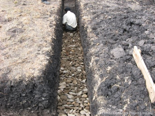 We set a layer of hard core down in one area where the trench had to be deeper than most places to get to the murram