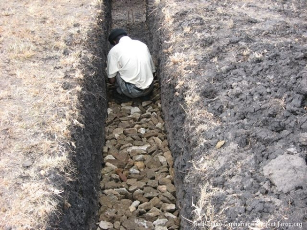 And then beat the \"hard\" out of it with sledge hammers and covered it with a layer of compressed murram so we could pour the footings on top of it safely.