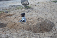 Mildred had a pre-natal visit at a clinic in Athi River today, so David stayed with dad and had his first day at work. It started in the sand pile.