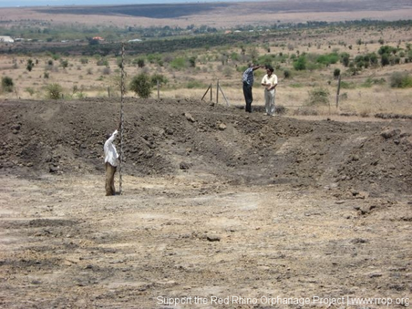 Peter helping Charles the surveyor take a depth measurement.  That\'s Gideon, the engineer and Jaswinder, the dozer owner in the background