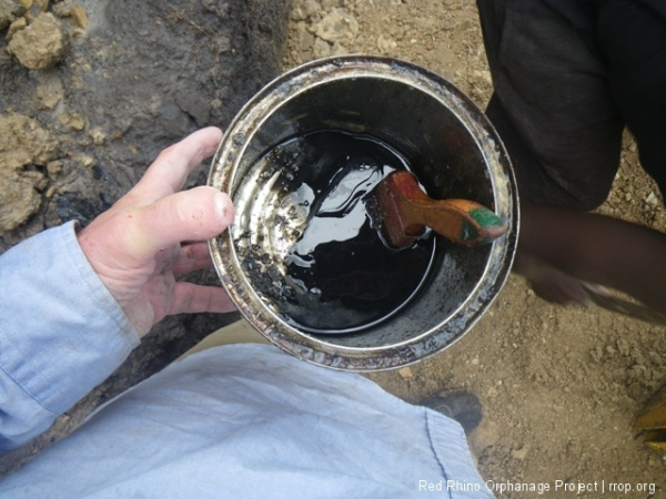 We brushed used motor oil on the compacting blade after every cleaning which helped a little.