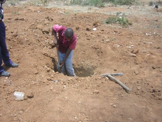 The grave had been dug, but too shallow, so we waited for it to be deepened.          