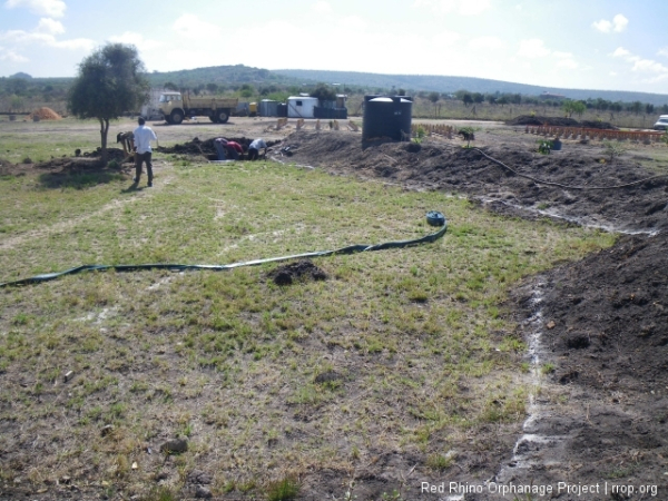 Here's a series of photos of their work on the area where we will place the six twenty four thousand liter tanks that will store our harvested rain water. It took about two weeks of very hard work. The black cotton soil is more like rock than dirt.