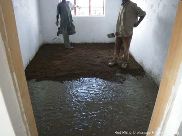 Then we laid down a very wet layer of mortar, cement and sand. That's the light grey stuff on the bottom.