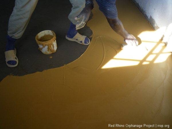 Using a rectangular trowel, also called a spreader, in a motion that's most like a pastry chef frosting a big cake