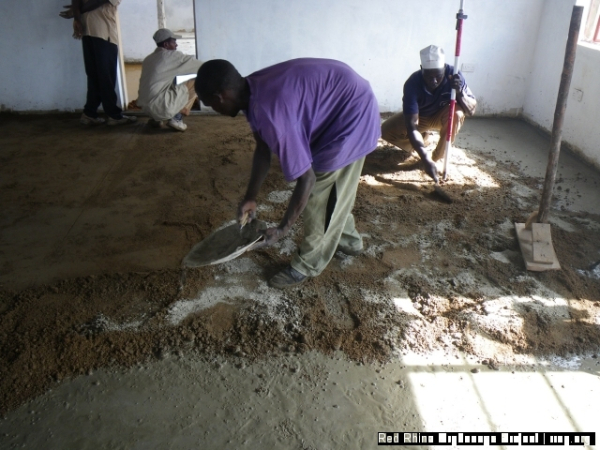 David adding cement to make the mixture drier.