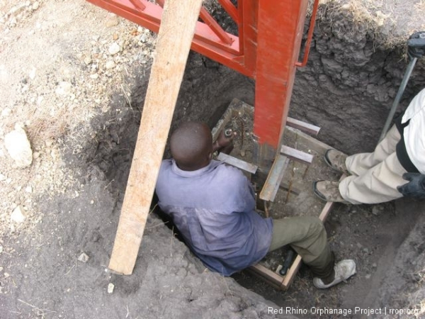 Then the rebar bending began again. We needed to reduce its area to about 16\" so it would fit nicely into the 20\" wide, 48\" high form which would hold the post. You can see the pieces of 2x2\" angled steel Edward had welded onto the bottom section of the posts to help secure it in the concrete.