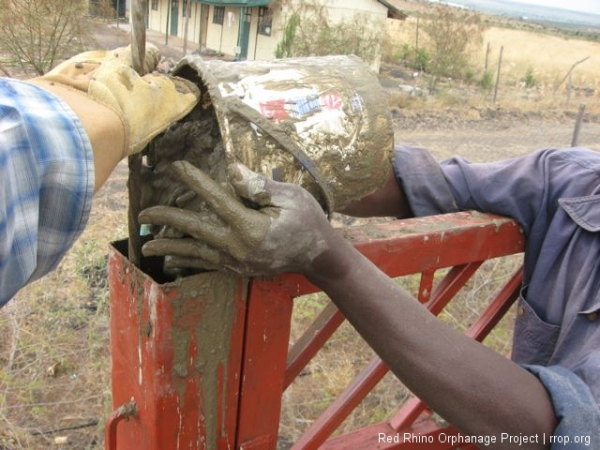 Then you and Benson, if you\'re lucky enough to have a Benson, climb up on the barrels and fill the 4x4\" posts with concrete one bucket at a time.