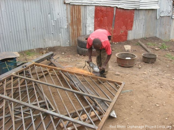 Julius, the welder, grinding off the rough spots.