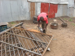 Julius, the welder, grinding off the rough spots.