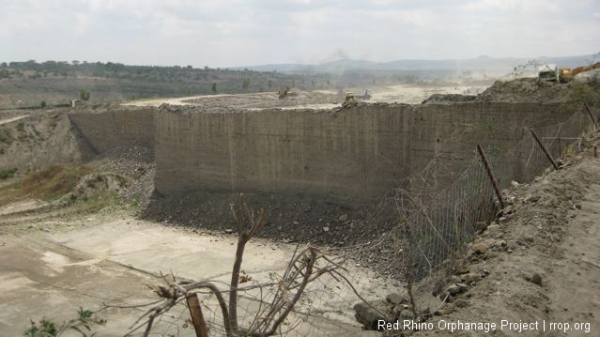 Those little ant-like things on top are huge bulldozers and dump trucks.