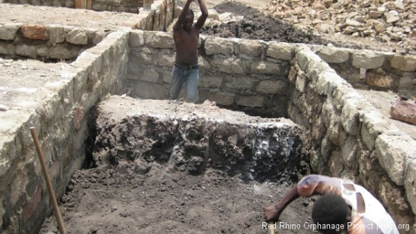 and then shovel it into one of the wheelbarrows