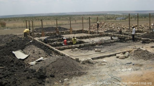 This is what things looked like Monday morning. The poles were all in place and the foundation walls were finished, all at the level of the slab we are going to pour. Because the ground slants downward, away, in this picture, the wall at the far end looks higher, but it\'s not.