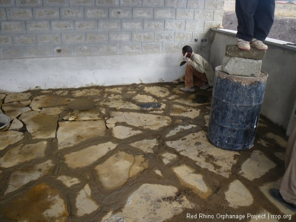 With the stones leveled and firmly placed, we started slinging the mortar.