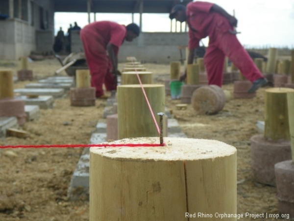 Each one has to be leveled. If it is within 20 mm of the leveling string, it can be made up with mortar under the concrete base.