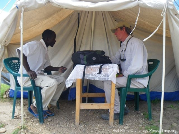 We're back at the tent, where we're going to have the snacks I promised. Mandaazi and tea. A kind of deep fried sweet dough and loose leaf tea, boiled with water and milk and sugar. Just like you'd get at Joyce's.