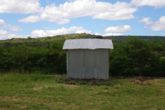 Here's the out house, or pit latrine, as we call them here. It semi-collapsed after the first big rain this spring, and has been a big problem since then. I'll spare you the noisome details.