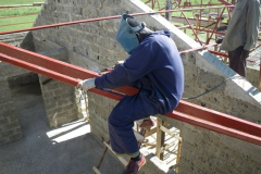 Peter welding purlins to the valley beams.