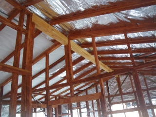 This is the longer of the two laminated beams which put some starch in the skeleton, and the interior rafters with the double sided aluminium insulation. There's an additional 