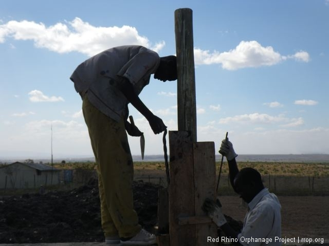 Some old friends were back on the job. Murafu here finishing the concreting of the posts.