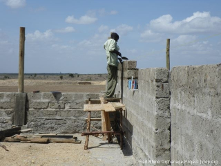 The walls were getting higher, so we pulled out the scaffolding that Opiyo made just before I came home