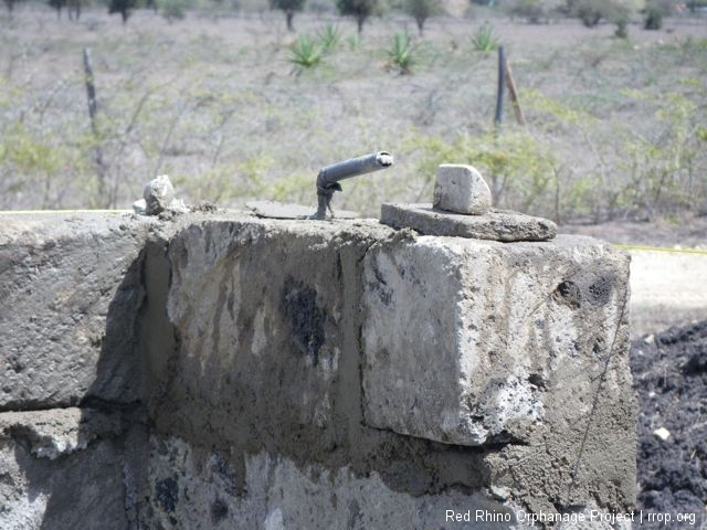 Murafu was in the doghouse because he had come without his mason\'s tools, so he had to take this broken trowel to be welded at lunch time.