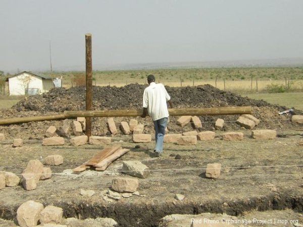 I\'ve jumped ahead to today, day two. That\'s Murafu carrying one of the very heavy fourteen foot poles we set in place today.