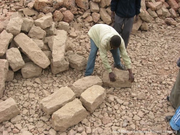 The quarry guys lay out the stones.