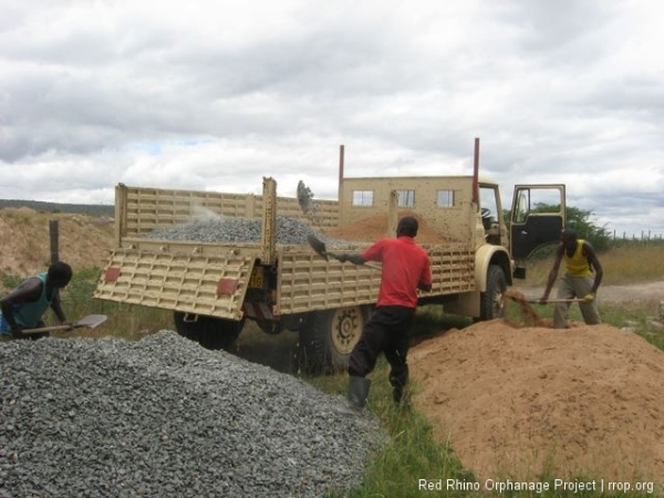 The sand and ballast need transporting up to the site. If given the choice, always choose sand. Shoveling sand is driving good nails into soft wood; shoveling ballast is riding an old bicycle with nearly flat tires.